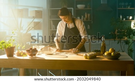 Professional Chef Sprinkles Flour and Kneads Dough on a Wooden Table in a Modern Home Kitchen. The Process of Making a Beautiful Dough. Homemade Cakes For a Pastry Shop. Startup.