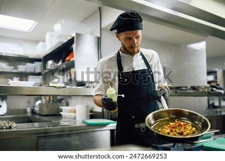 Professional chef working in the kitchen in a restaurant. Copy space.