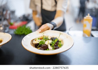 professional chef's hands cooking beetroot salad with feta cheese in a restaurant kitchen - Powered by Shutterstock