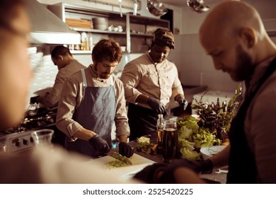 Professional chefs working together in a busy restaurant kitchen - Powered by Shutterstock