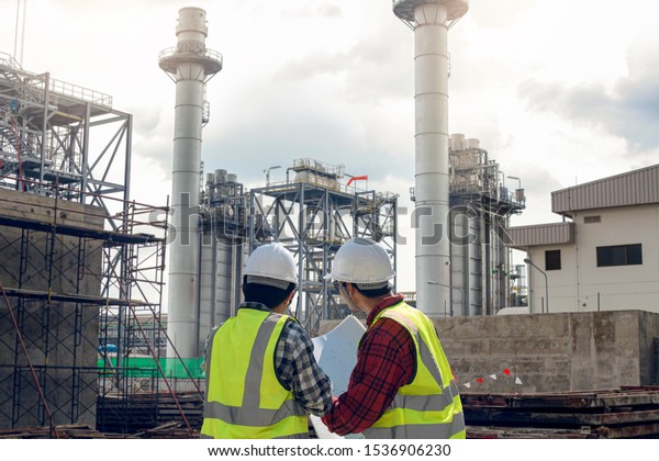 Professional\
civil engineer project construction cogeneration electrical plant.\
Engineer foreman discussion concept\
work.