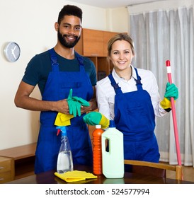 Professional Cleaners Cleaning And Dusting In Ordinary House