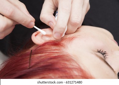 Professional Cleaning The Ear Before Piercing A Young Girl Ear. Tragus Type