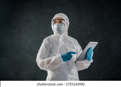 Professional cleaning staff with a To wear protective medical mask and PPE suit use chemical sprayer protect decontamination indoors. remove bacterias, viruses, and infections from the surface. COVID - Shutterstock ID 1755143900