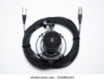 Professional Condenser Microphone On White Background. High Fidelity Mic For Sound Recording Studio. Record Vocals And Live Music In High Quality. Royalty Free Photo For Musical Wallpaper Background