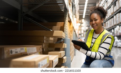 Professional Confident Worker Wearing Reflective vest Checks Stock Inventory with Digital Tablet Computer in the Retail Warehouse full of Shelves with Goods. Working in Logistics, Distribution Center - Powered by Shutterstock