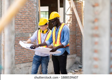 Professional Construction and  Engineer team Working on workplace. Professional black architect and construction worker working look at blueprint plan on site. - Shutterstock ID 1888539607