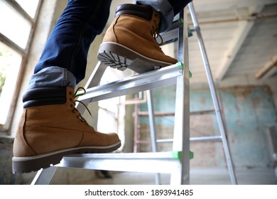 Professional constructor on ladder in old building, closeup - Shutterstock ID 1893941485