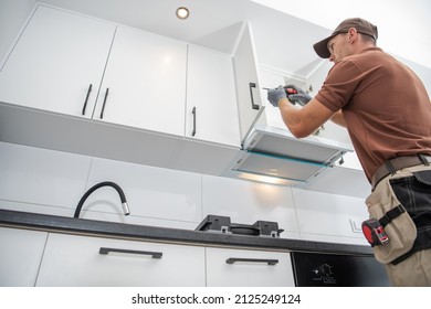 Professional Contractor Cabinetmaker in His 40s Assembling of New Apartment Kitchen Cabinets. Modern Furnishing. - Shutterstock ID 2125249124