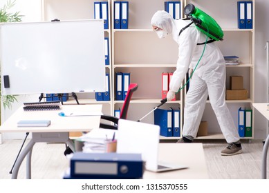 Professional Contractor Doing Pest Control At Office 