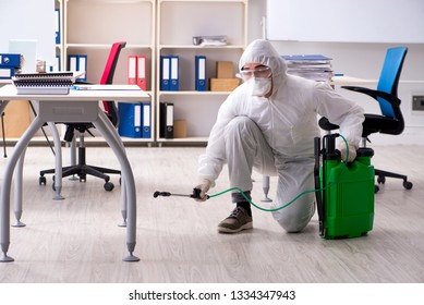Professional Contractor Doing Pest Control At Office 