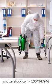 Professional Contractor Doing Pest Control At Office 