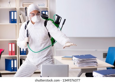Professional Contractor Doing Pest Control At Office