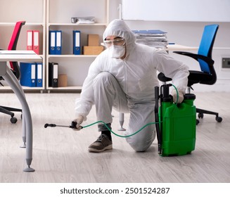 Professional contractor doing pest control at office - Powered by Shutterstock