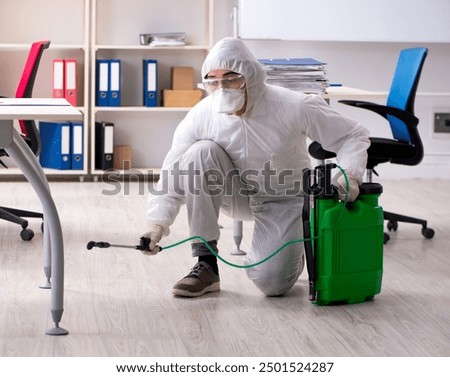 Professional contractor doing pest control at office