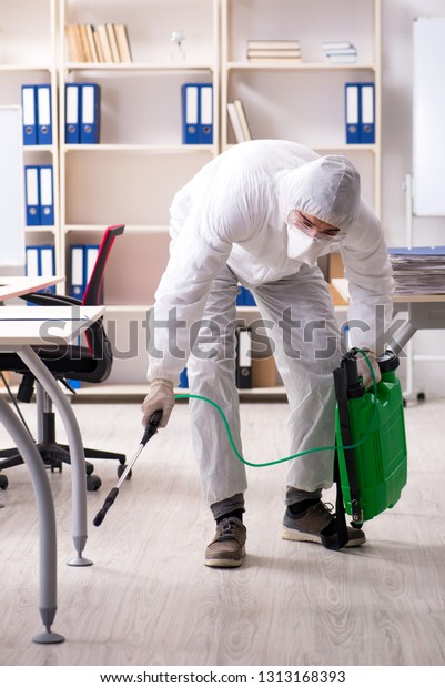 Professional\
contractor doing pest control at\
office