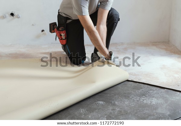 Professional Contractor Removing Old Linoleum Flooring Stock Image