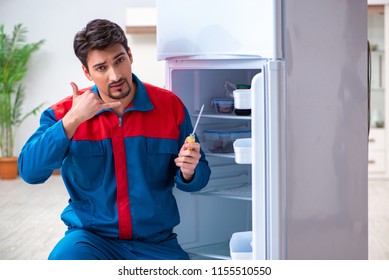 Professional Contractor Repairing Broken Fridge