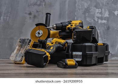 Professional cordless tool set. Angle grinder, screwdriver and impact wrench with batteries and tool box. Concept for construction, repair, renovation and DIY projects
