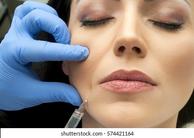 Professional Cosmetologist Making Facial Injection