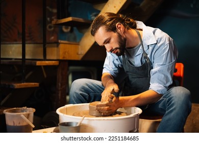 Professional craftsman potter making jug of clay on the potter's wheel circle in workshop, Traditional handicraft working, Creativity and art of pottery - Powered by Shutterstock