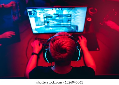 Professional cyber gamer studio room with personal computer armchair, keyboard for stream in neon color blur background. Soft focus. - Shutterstock ID 1526945561
