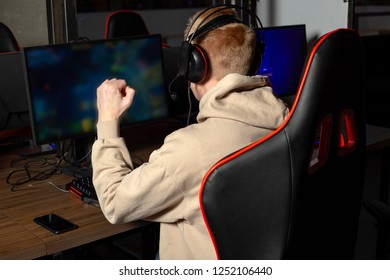 Professional cyber sportman trains for the championship. Male hooded gamer playing online game on pc computer Gaming Club. - Shutterstock ID 1252106440