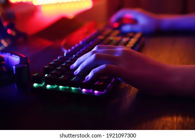 Professional cyber video gamer studio room with personal computer armchair, keyboard for stream in neon color blur background. Soft focus. - Shutterstock ID 1921097300