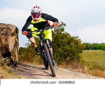 Professional Cyclist Riding the Bike at the Rocky Trail. Extreme Sport Concept. Free Space for Text. - Shutterstock ID 562680862