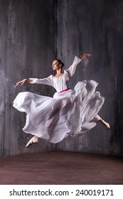 professional dancer in stage costume jumping