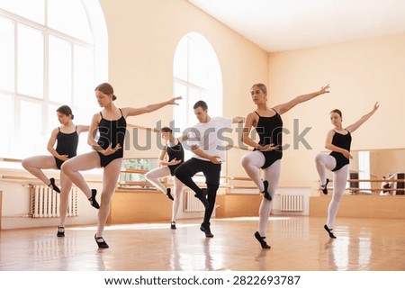 Professional dancers practicing ballet in dance studio