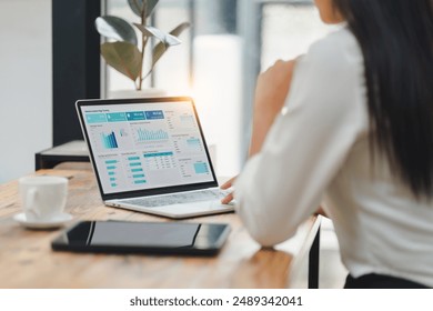 Professional data analyst using data visualizations dashboard on computer monitor for data business analysis and Data Management System - Powered by Shutterstock