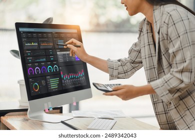Professional data analyst using data visualizations dashboard on computer monitor for data business analysis and Data Management System
