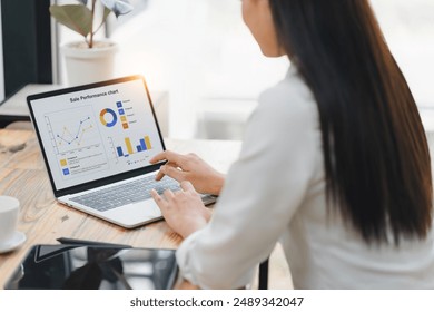 Professional data analyst using data visualizations dashboard on computer monitor for data business analysis and Data Management System - Powered by Shutterstock