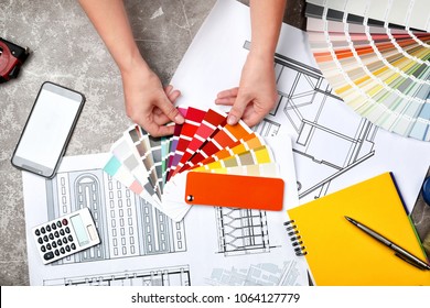 Professional decorator working at table, top view
