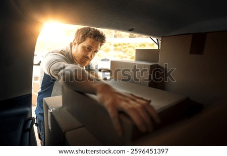 Professional delivery man loading packages into a van, express delivery service