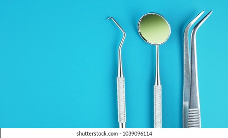 Professional Dentist tools in dental office: dentist mirror, forceps curved, explorer curved, dental explorer angular and explorer curved with chip, right. Dental Hygiene and Health conceptual image