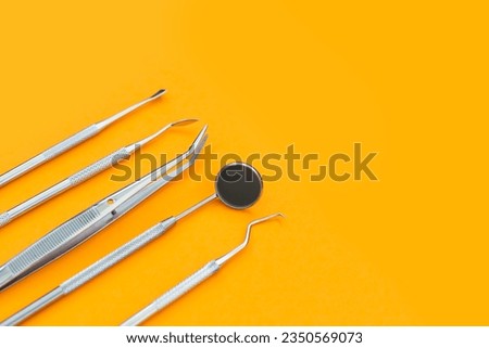 Professional Dentist tools in dental office: dentist mirror, forceps curved, explorer curved, dental explorer angular and explorer curved with chip, right. Dental Hygiene and Health