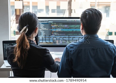 Professional Developer programmer cooperation meeting and brainstorming and programming in website working a software outsourcing and coding technology, writing codes and database.