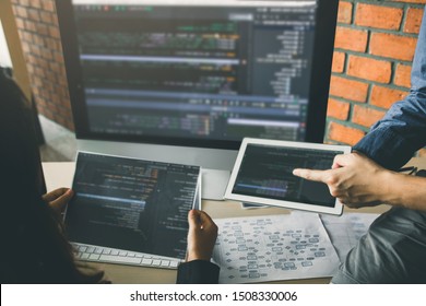 Professional development programmer cooperating meeting programming website working a software in office room.
