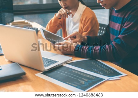 Professional Development programmer cooperating meeting and brainstorming and programming website working in a software and coding technology, writing codes and data code.