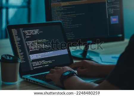 Professional Development programmer typing on a laptop Computer Keyboard. Screens Show Coding Language User Interface. Program Development, software, and coding technology, ChatGPT, Website design. 
