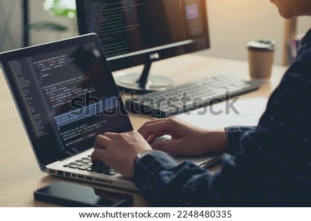Professional Development programmer typing on a laptop Computer Keyboard. Screens Show Coding Language User Interface. Program Development, software, and coding technology, ChatGPT, Website design. 