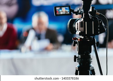 Professional Digital Camera Recording Presentation Of A Blurred Speaker Wearing Suit, Live Streaming Concept