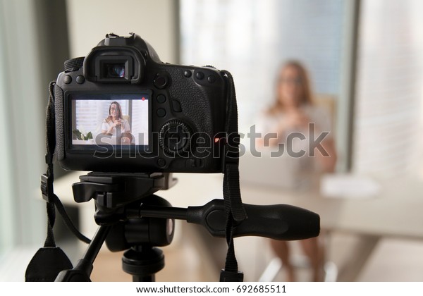 Professional digital equipment recording video\
blog of businesswoman, online business coach making presentation\
for website, filming popular vlog or master class for videoblog\
channel, focus on\
camera