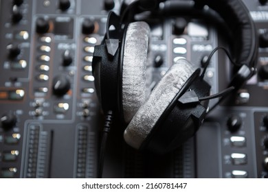 Professional Dj Headphones On Sound Mixer. High Quality Disc Jockey Head Monitors. Curated Collection Of Royalty Free Images Of Audio Equipment For DJs And Musicians. Download Party Poster Template