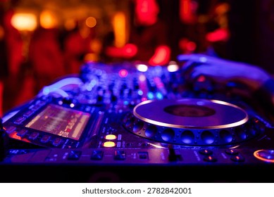 Professional dj mixer controller with lights at nightclub party close up