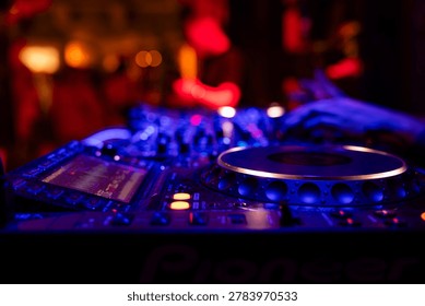 Professional dj mixer controller with lights at nightclub party close up