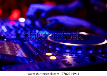 Professional dj mixer controller with lights at nightclub party close up