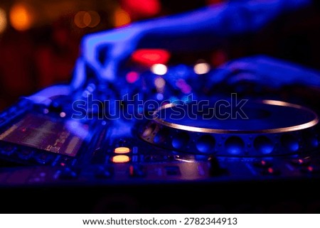 Professional dj mixer controller with lights at nightclub party close up